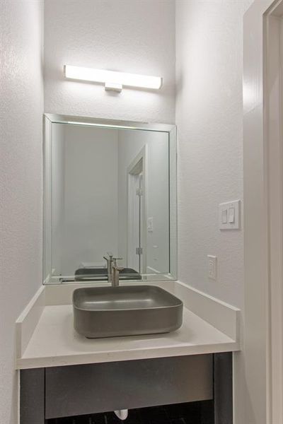 Half bath with vessel sink to give it a contemporary feel.