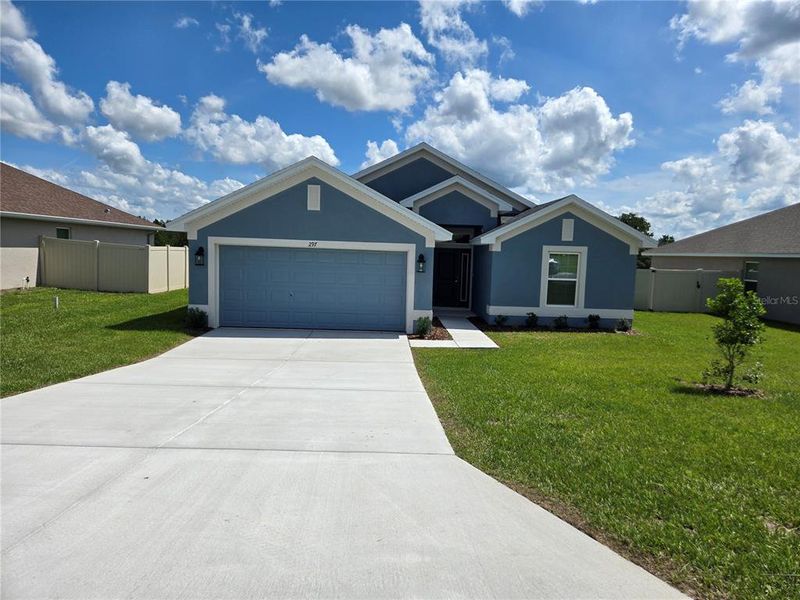 Front exterior of a new home in Twisted Oaks, Beverly Hills, FL, highlighting curb appeal (Image 2).