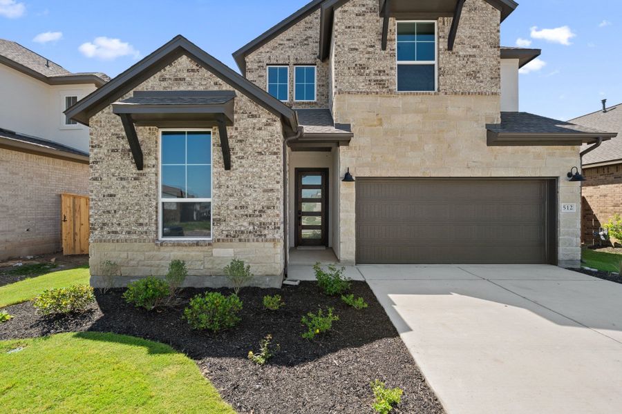 Front exterior of a new home in Lariat, Liberty Hill, TX, highlighting curb appeal (Image 25).