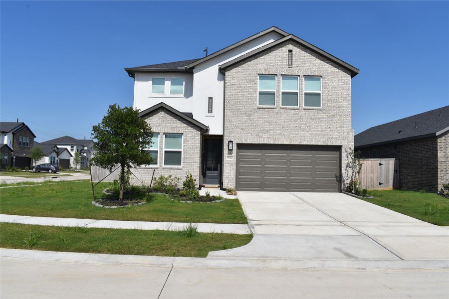 Front exterior of a new home in Bridge Creek 45s and 50s, Cypress, TX, highlighting curb appeal (Image 24). Front exterior of a new home in Bridge Creek 45s and 50s, Cypress, TX, highlighting curb appeal (Image 24).