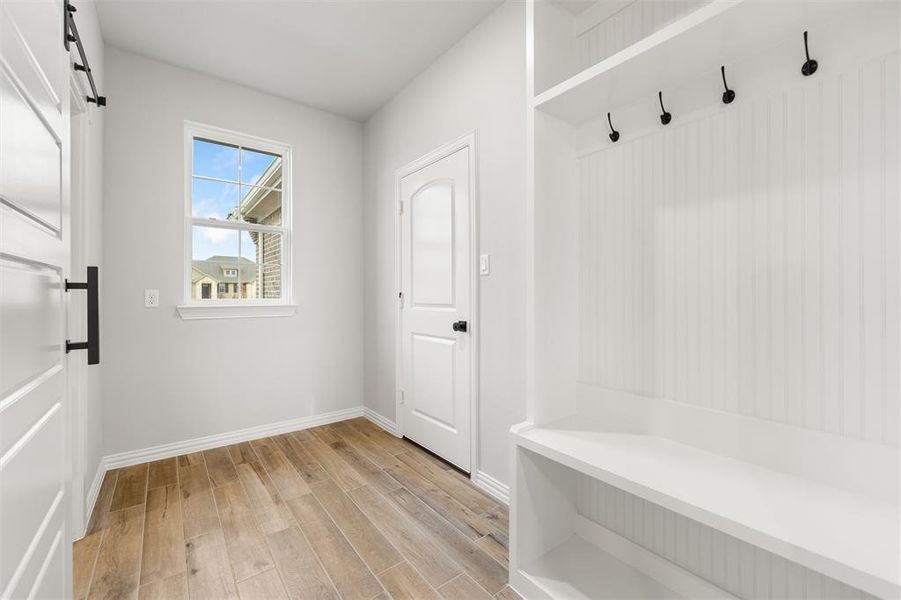 Mudroom with light wood-style floors and baseboards Mudroom with light wood-style floors and baseboards