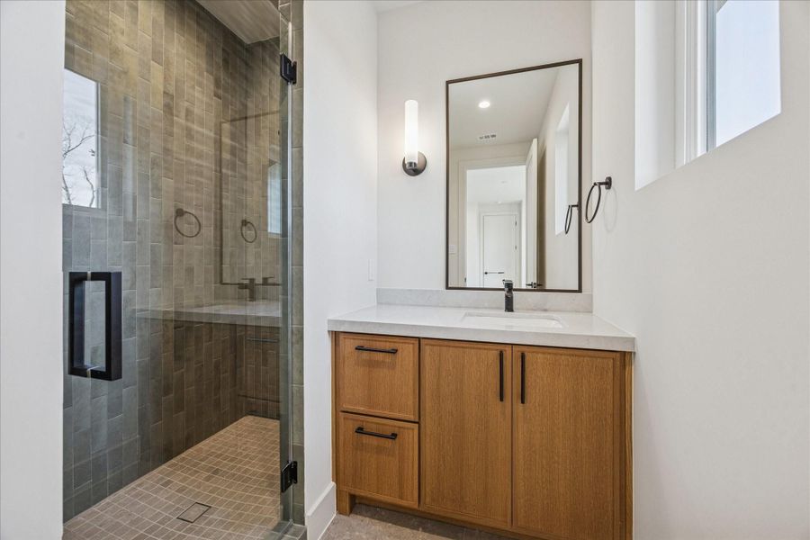 Ensuite bath with gorgeous green Italian porcelain tile in the shower and a polished dolomite countertop.