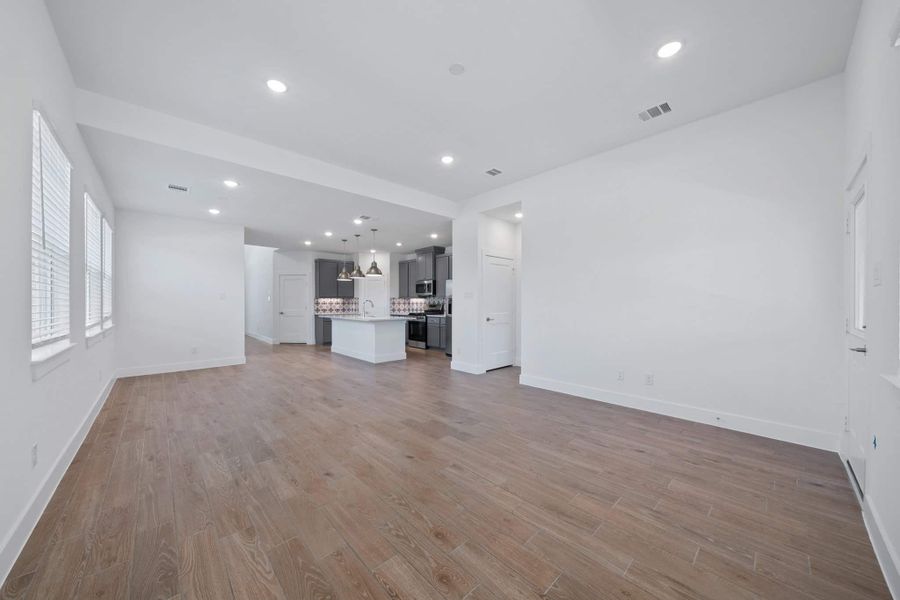 Representative unfurnished interior of a home built from the Sage by Chesmar Homes in Sunterra, Katy (Image 6).