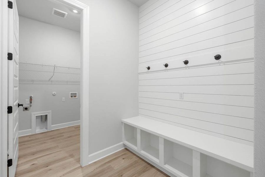 Mudroom and laundry room are conveniently adjacent as you enter from the garage.