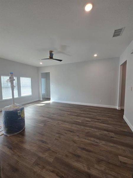 Spare room with dark wood finished floors, recessed lighting, and a ceiling fan