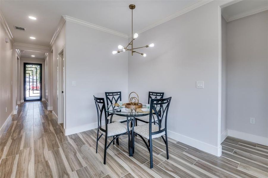 Dining room featuring crown molding and an inviting chandelier