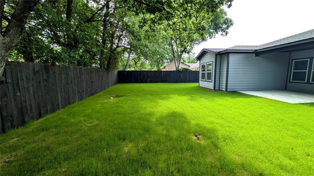 View of yard featuring a fenced backyard and a patio area