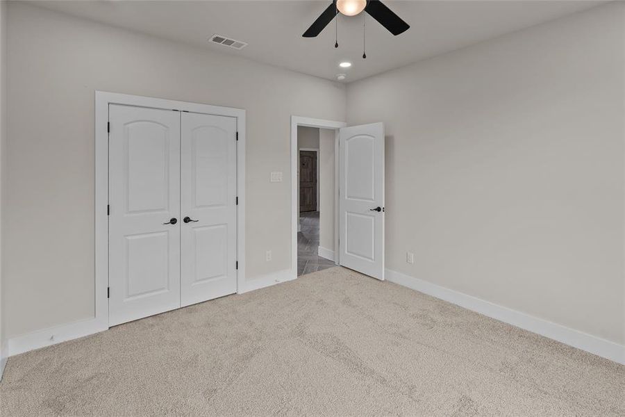 Unfurnished bedroom featuring carpet floors, a closet, baseboards, ceiling fan, and recessed lighting