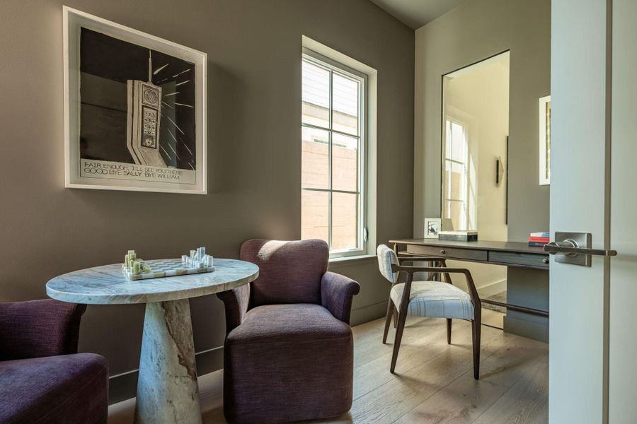 Hardwood floors and tall windows frame this versatile home workspace. Hardwood floors and tall windows frame this versatile home workspace.