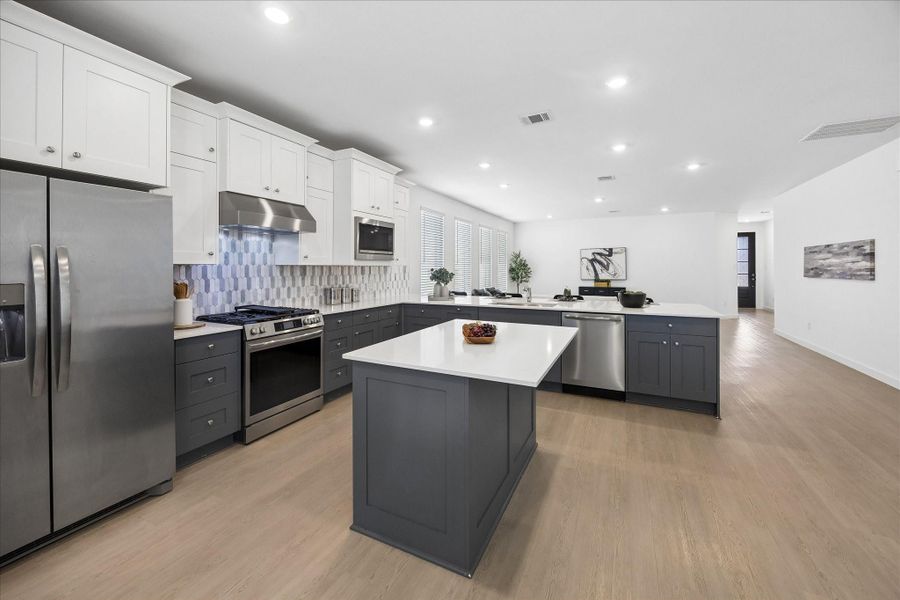 Pull up a stool and get to work. The center island adds valuable prep space with an overhang for seating, so someone can keep you company while you chop, mix and get dinner on the table.
