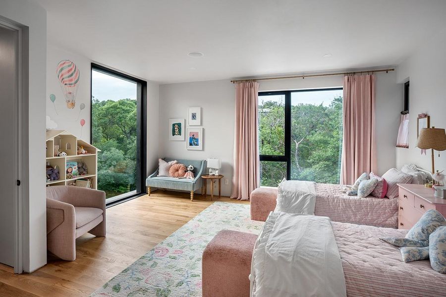 Secondary upstairs master bedroom overlooking the pool and trees.