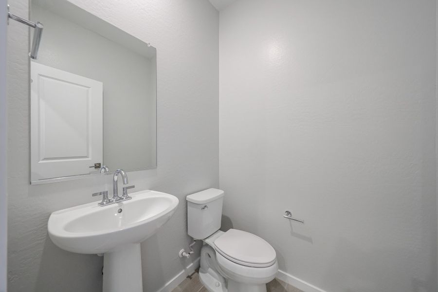 A bathroom with a toilet and sink.