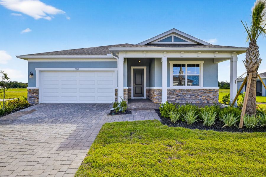 Front exterior of a new home in Windwater, Parrish, FL, highlighting curb appeal (Image 1).