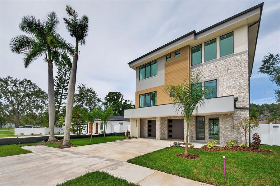 Front exterior of a new home in , St. Petersburg, FL, highlighting curb appeal (Image 1).