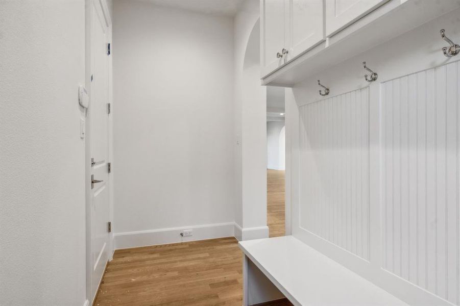 Mudroom with light hardwood / wood-style floors