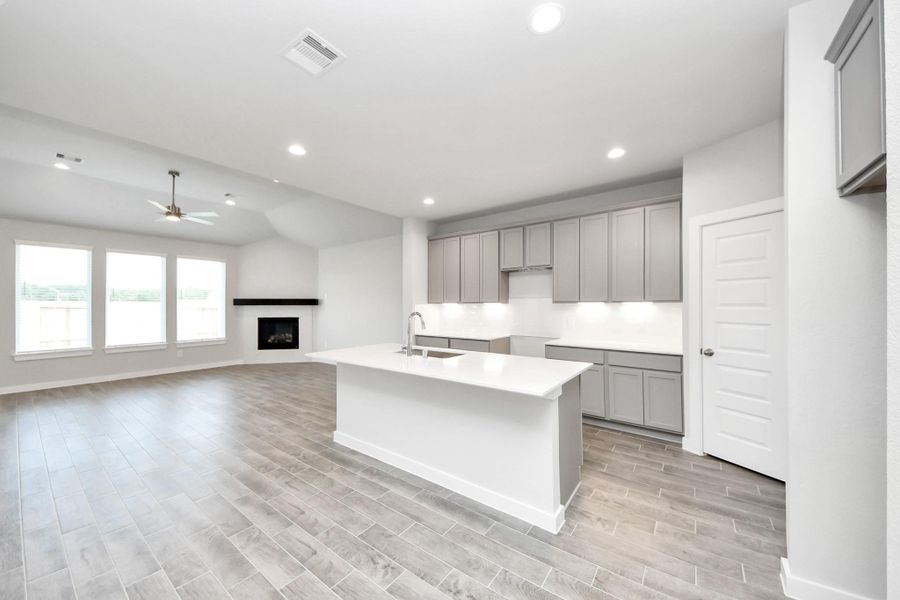 The kitchen is a culinary haven, featuring granite countertops, a tile backsplash, stainless steel appliances, 42” upper cabinets, and undercabinet lighting. The kitchen is a culinary haven, featuring granite countertops, a tile backsplash, stainless steel appliances, 42” upper cabinets, and undercabinet lighting.