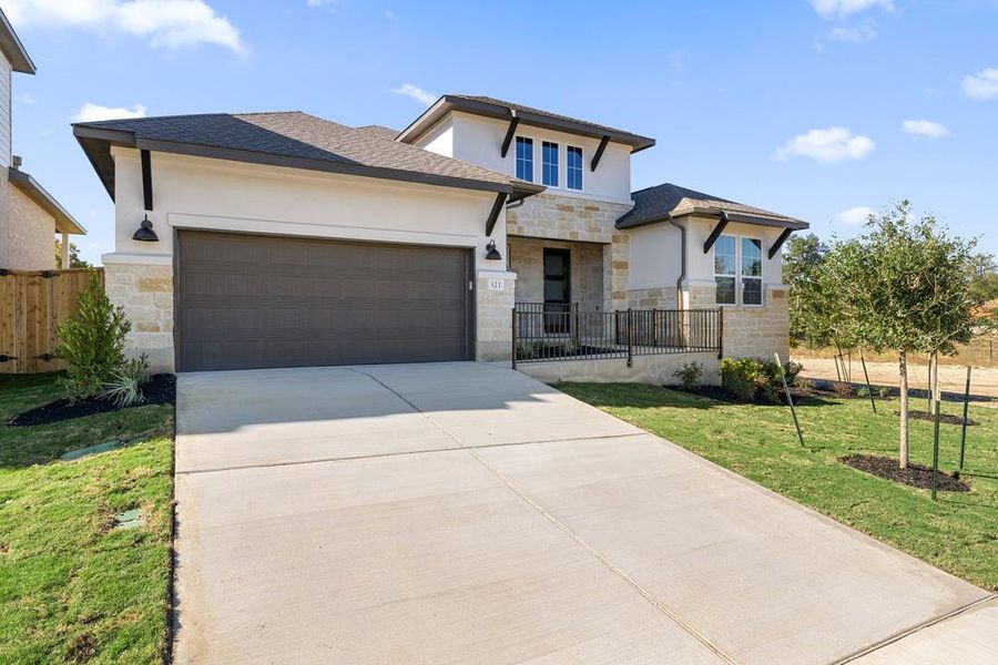 Front exterior of a new home in Lariat, Liberty Hill, TX, highlighting curb appeal (Image 22).