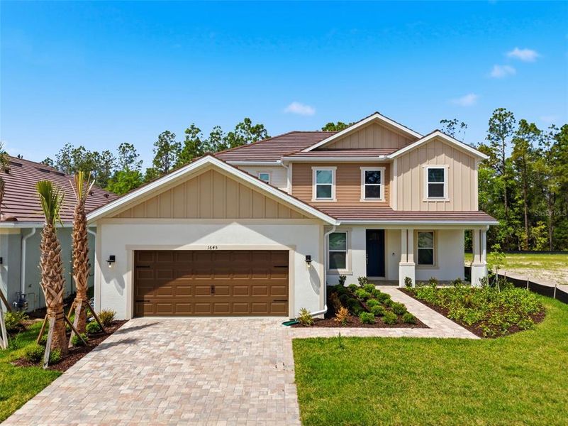 Front exterior of a new home in Hammock at Two Rivers, Zephyrhills, FL, highlighting curb appeal (Image 29).