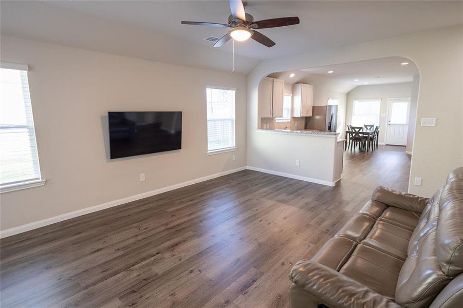 The space flows seamlessly into the dining and kitchen areas.