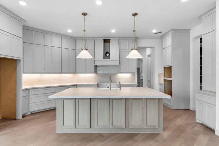 bright, spacious kitchen that immediately feels like the heart of the home.kitchen with abundant cabinets, a large island