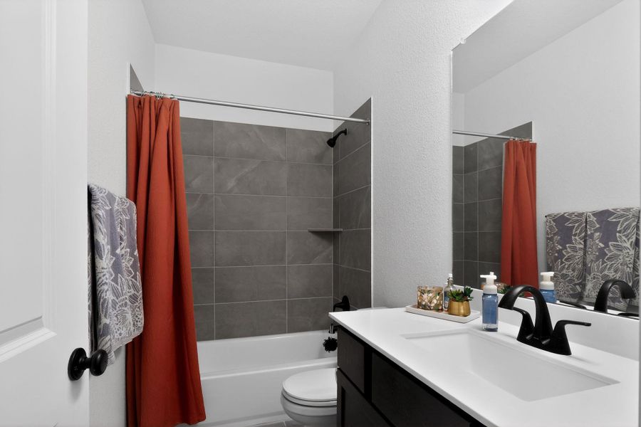 Bathroom with a matte black faucet, a white undermount sink, and a white countertop Bathroom with a matte black faucet, a white undermount sink, and a white countertop