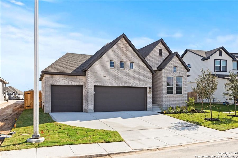 Front exterior of a new home in Village at Three Oaks, Seguin, TX, highlighting curb appeal (Image 2). Front exterior of a new home in Village at Three Oaks, Seguin, TX, highlighting curb appeal (Image 2).