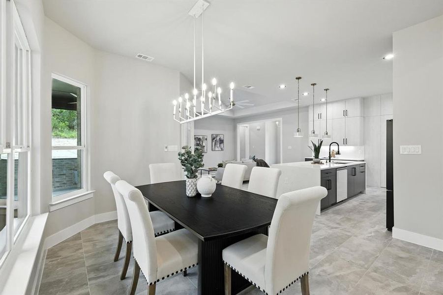 Dining space with recessed lighting and a chandelier