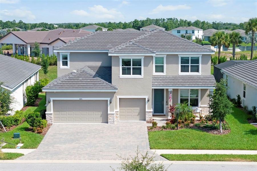 Front exterior of a new home in Star Farms at Lakewood Ranch, Bradenton, FL, highlighting curb appeal (Image 25). Front exterior of a new home in Star Farms at Lakewood Ranch, Bradenton, FL, highlighting curb appeal (Image 25).