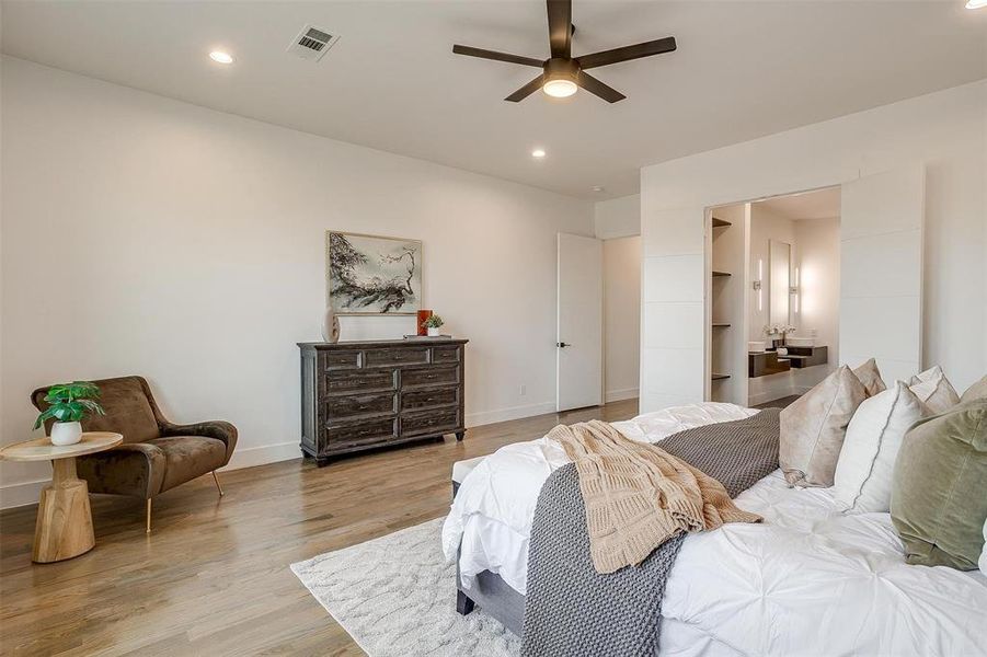 Bedroom featuring light wood-type flooring, visible vents, baseboards, and recessed lighting