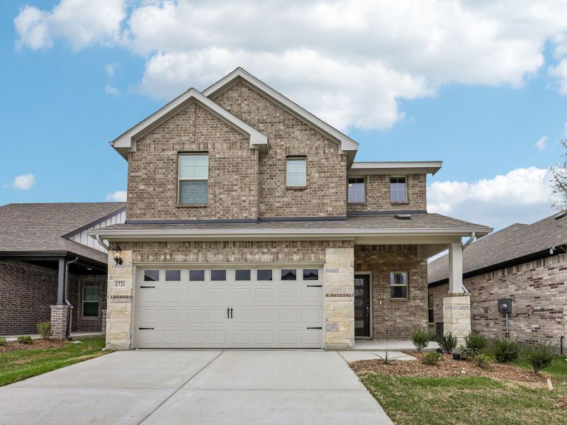 Front exterior of a new home in Parks at Foster Crossing - Spring Series, Anna, TX, highlighting curb appeal (Image 1). Front exterior of a new home in Parks at Foster Crossing - Spring Series, Anna, TX, highlighting curb appeal (Image 1).
