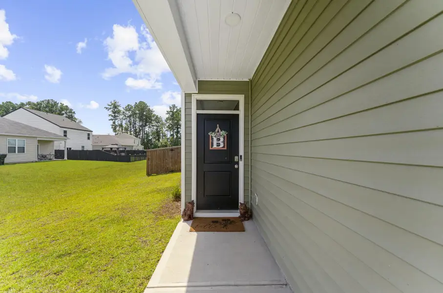 Exterior details and patio area of a home in Pine Hills at Cane Bay, Summerville (Image 24).