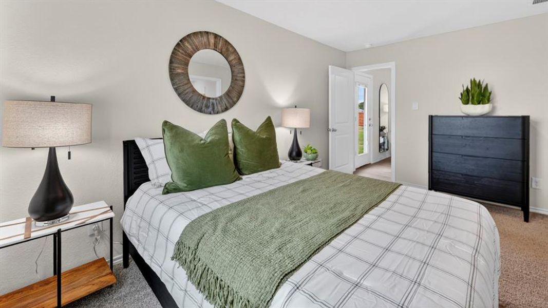 Carpeted bedroom featuring light-toned walls and a black slatted headboard Carpeted bedroom featuring light-toned walls and a black slatted headboard