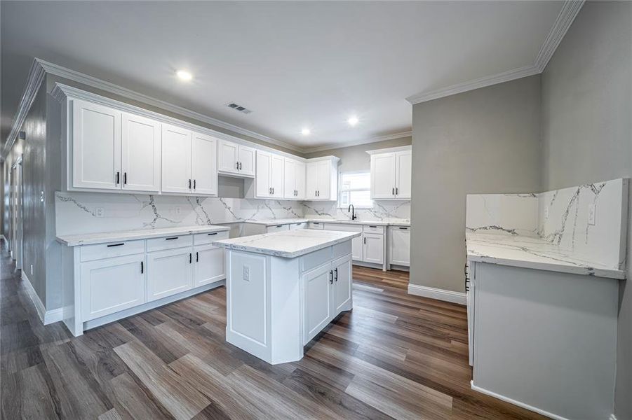 Kitchen featuring a kitchen island, white cabinetry, and dark hardwood / wood-style flooring