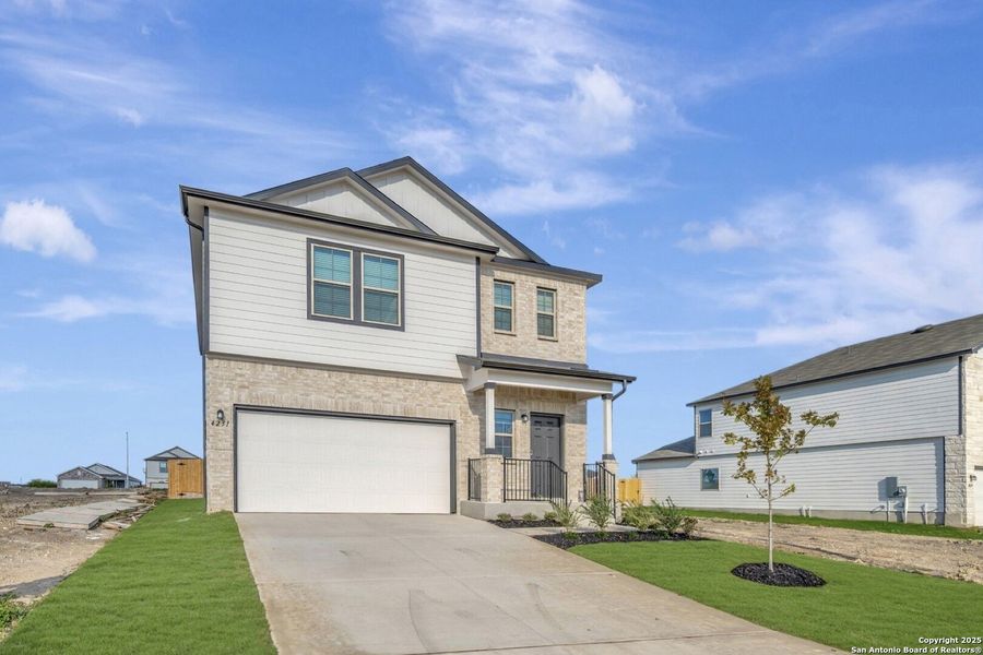 Front exterior of a new home in Park Place, New Braunfels, TX, highlighting curb appeal (Image 2). Front exterior of a new home in Park Place, New Braunfels, TX, highlighting curb appeal (Image 2).