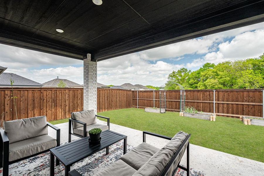 Fenced backyard with an outdoor living space and a patio