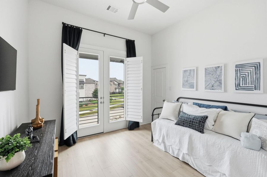 Bedroom 2:  Bright and inviting bedroom with elegant French doors opening to a scenic view, perfect for relaxation.