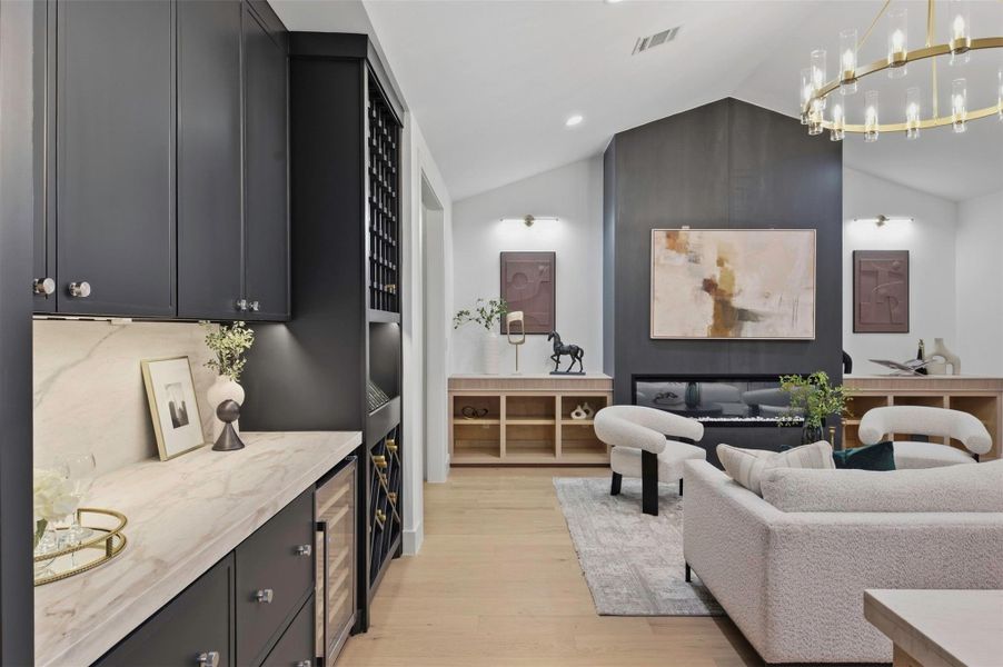 Built-in wine bar features custom cabinetry and a dedicated beverage refrigerator for effortless entertaining.