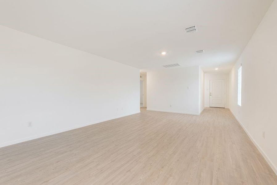 Empty room with light hardwood / wood-style floors