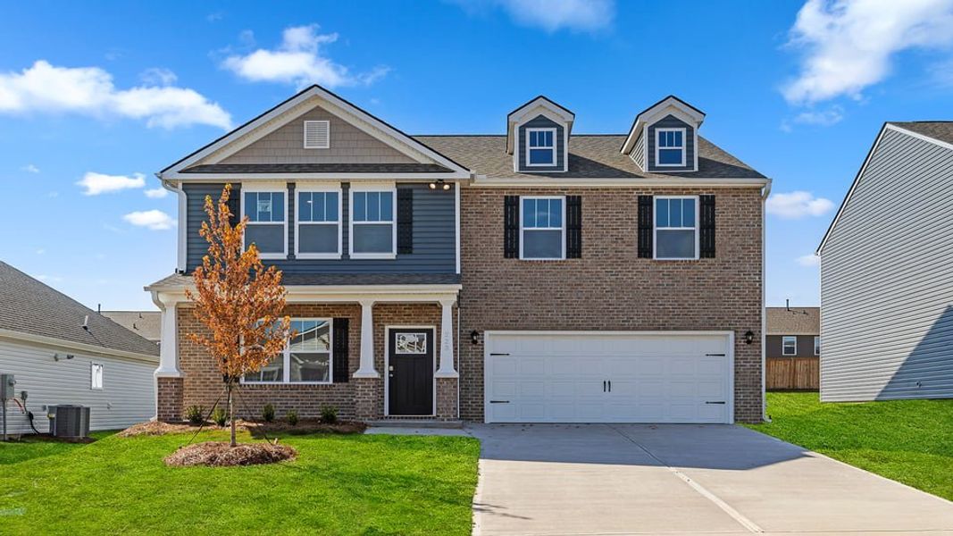 Front exterior of a new home in Durbin Meadows Traditions, Fountain Inn, SC, highlighting curb appeal (Image 1).