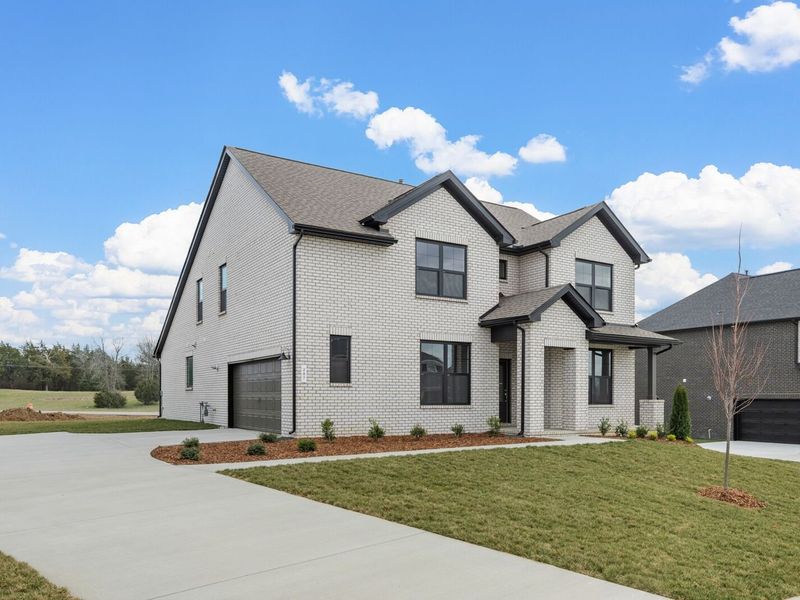 Front exterior of a new home in Benders Cove, Mount Juliet, TN, highlighting curb appeal (Image 25). Front exterior of a new home in Benders Cove, Mount Juliet, TN, highlighting curb appeal (Image 25).