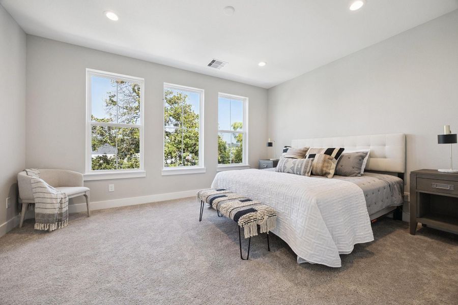 Large primary suite with a view of the tree tops Large primary suite with a view of the tree tops