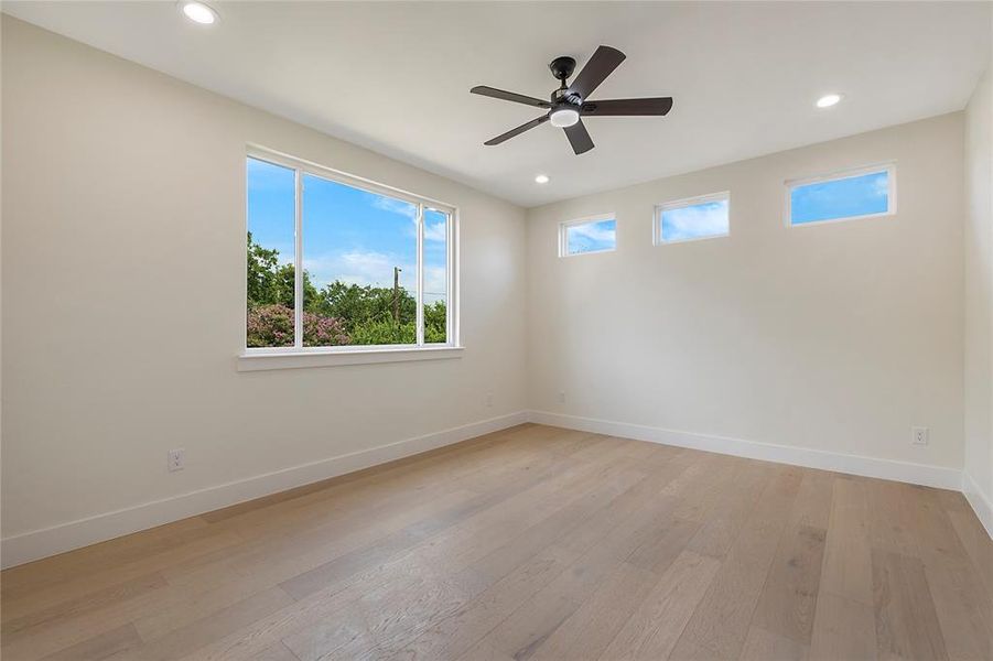 Spare room with hardwood / wood-style flooring and ceiling fan