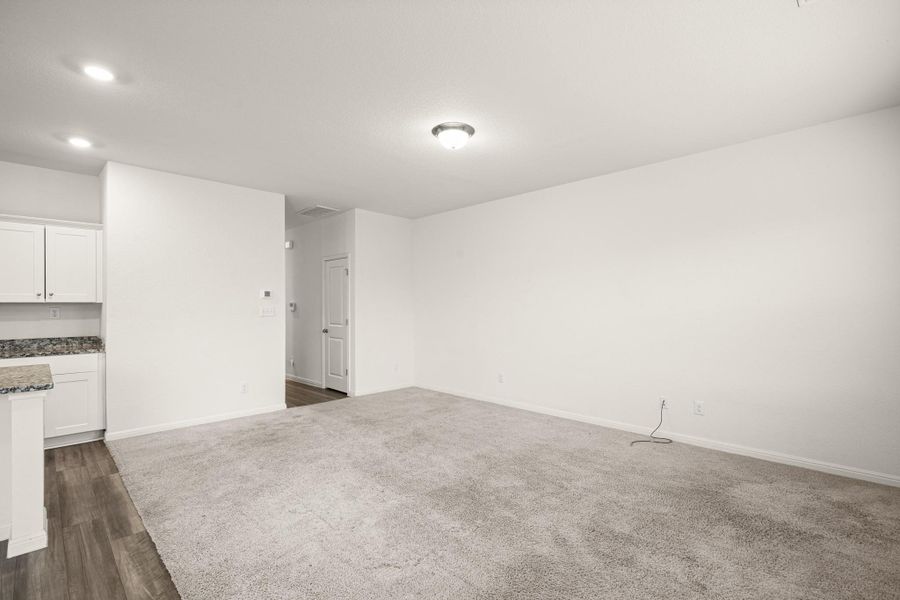 Unfurnished living room with baseboards