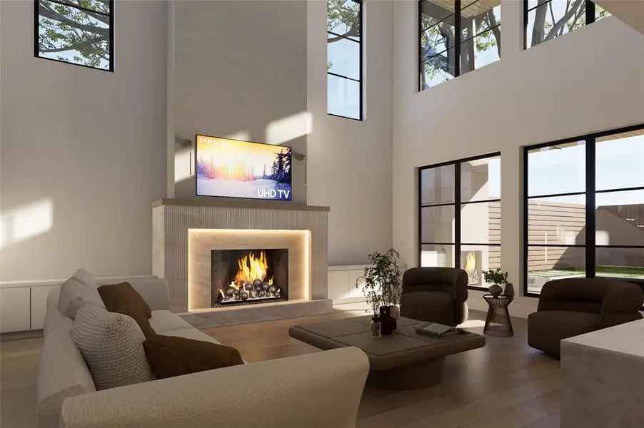 Living room with a lit fireplace, plenty of natural light, a wainscoted wall, wood finished floors, and a decorative wall