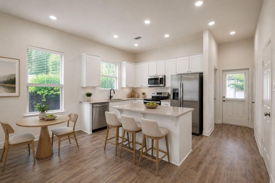 This virtually staged photo showcases a bright and inviting kitchen and dining area, featuring sleek stainless-steel appliances, elegant white cabinetry, perfect for modern living and entertaining.