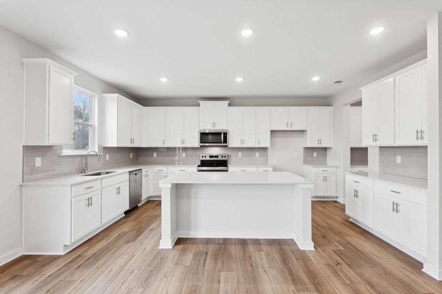 A kitchen with white cabinets. A kitchen with white cabinets.