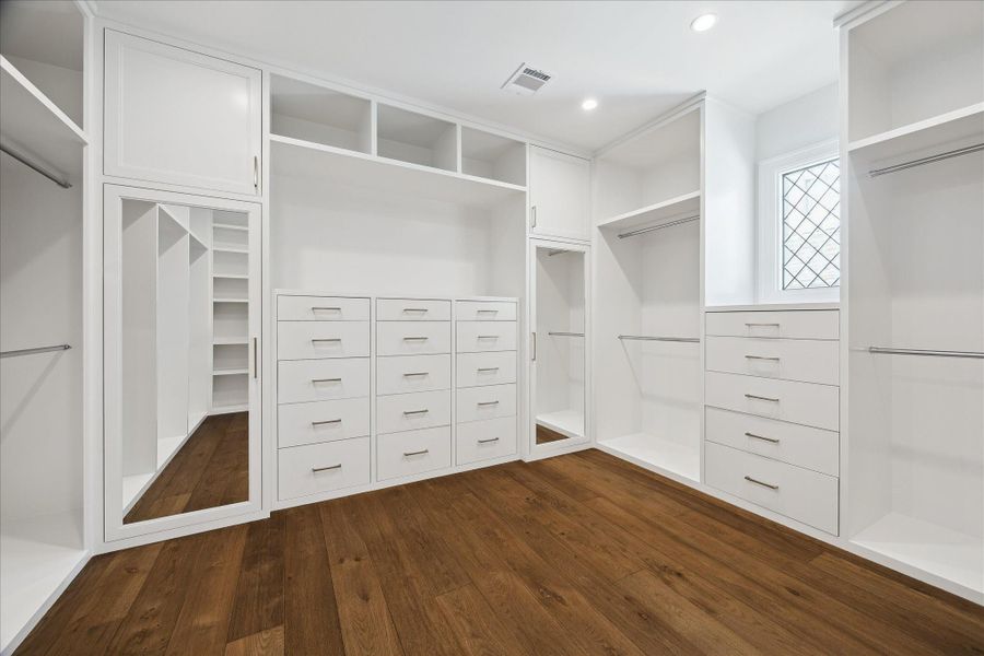 Primary closet with custom built-ins. Primary closet with custom built-ins.