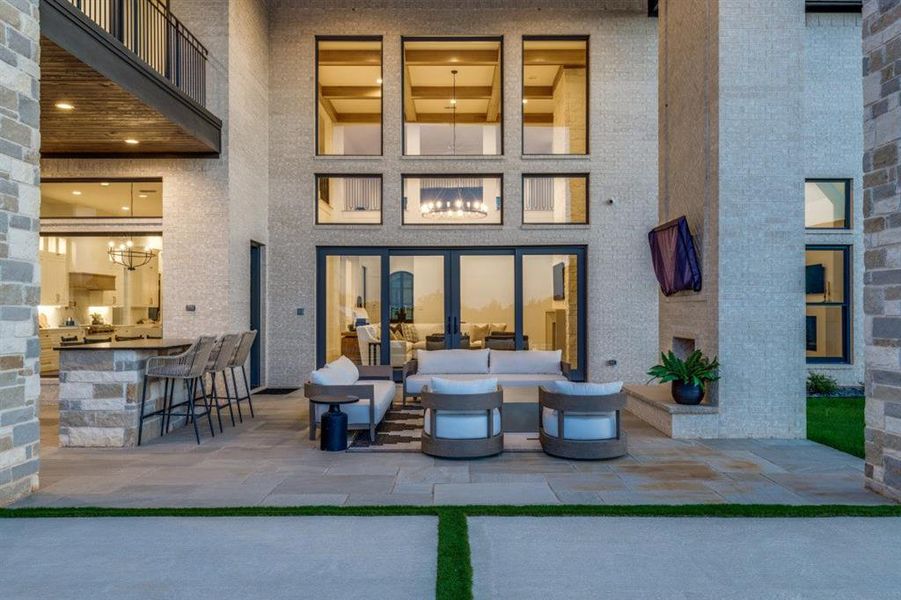 Rear view of property featuring a patio area and an outdoor living space Rear view of property featuring a patio area and an outdoor living space