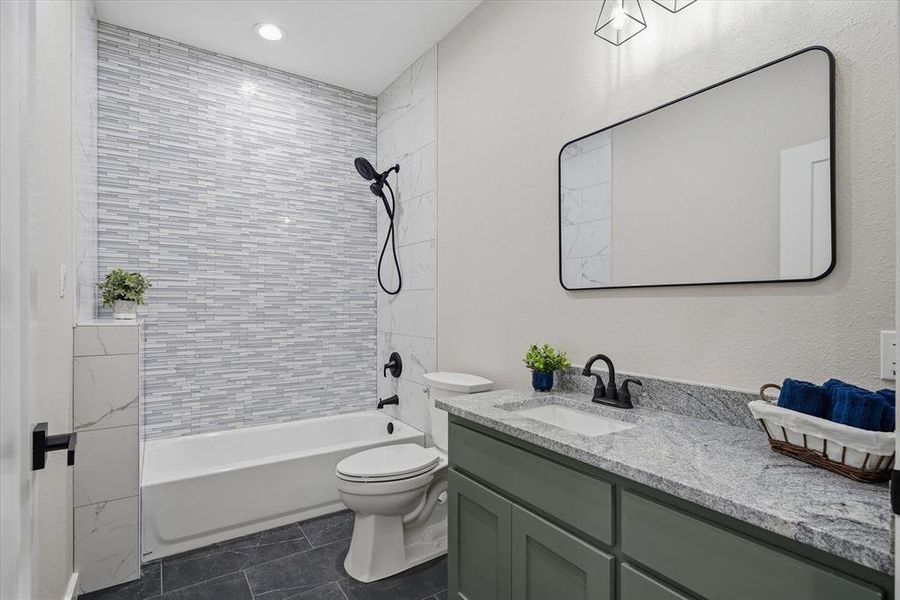 Near both guest bedrooms and mud room