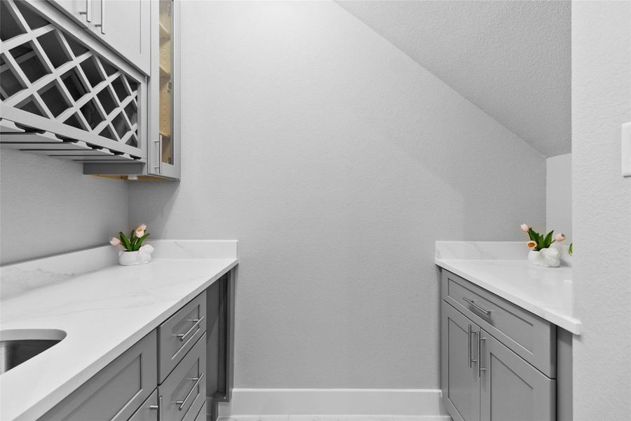 This tucked-away beverage station is the kind of detail you didn’t know you needed until it’s yours—custom cabinetry, dedicated wine storage, and a built-in fridge that makes hosting feel seamless. It’s perfectly positioned for entertaining without interrupting the flow of the main living space.